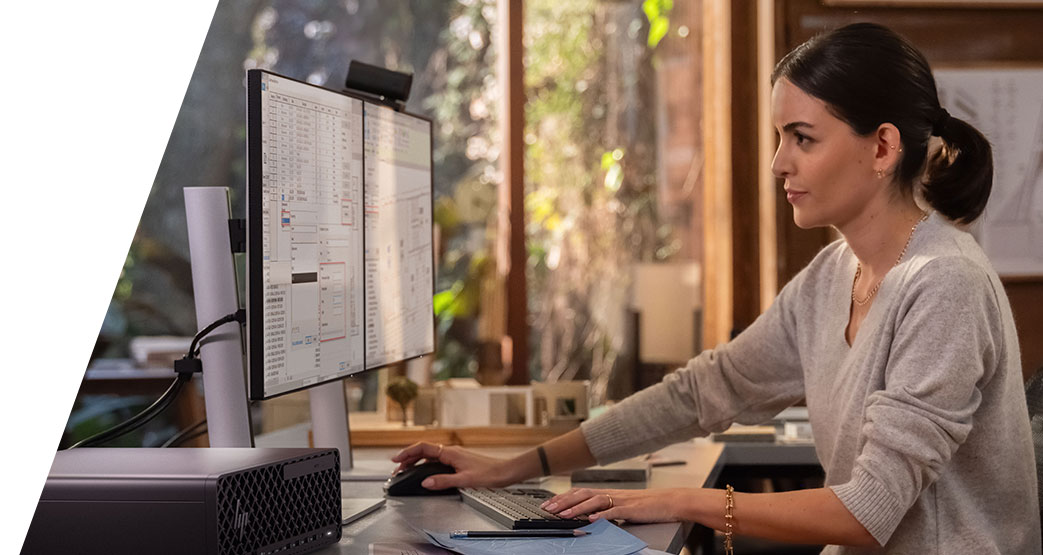 A girl working at a desktop computer.