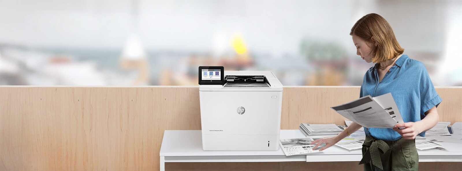 printer image with toner cartridges and a person looking at the printed papers