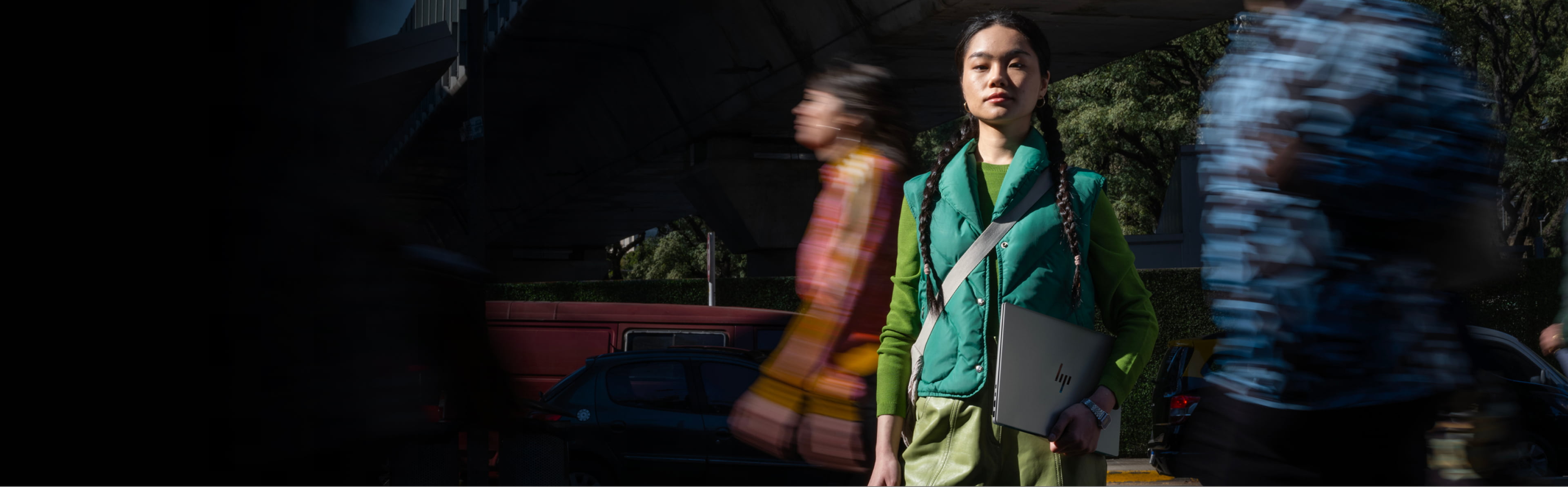 Standing woman holding an HP Laptop